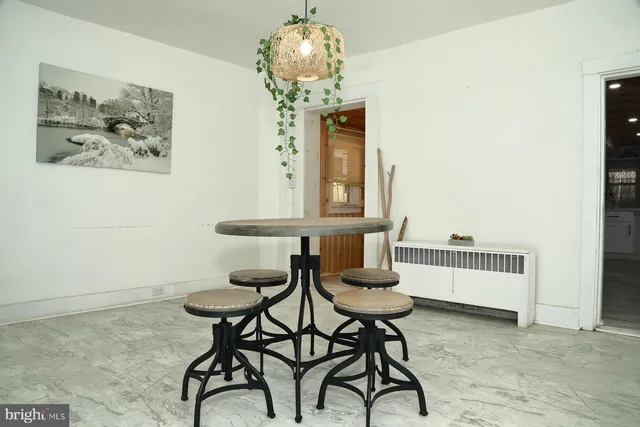 a view of a room with furniture and wooden floor
