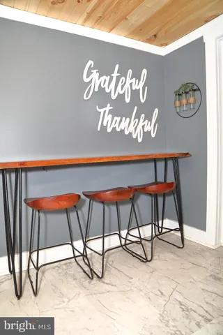 a view of an chairs and table in the room