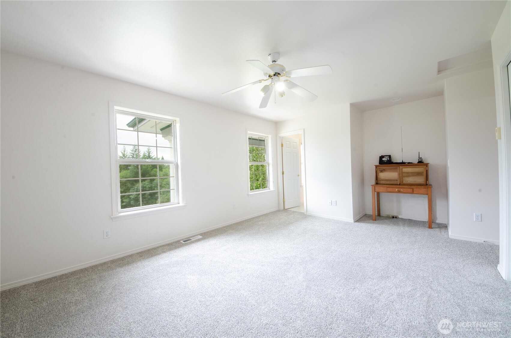 12832 Hunter Road Southwest Rochester, WA 98579 - Photo 13 of 40 an empty room with windows and ceiling fan