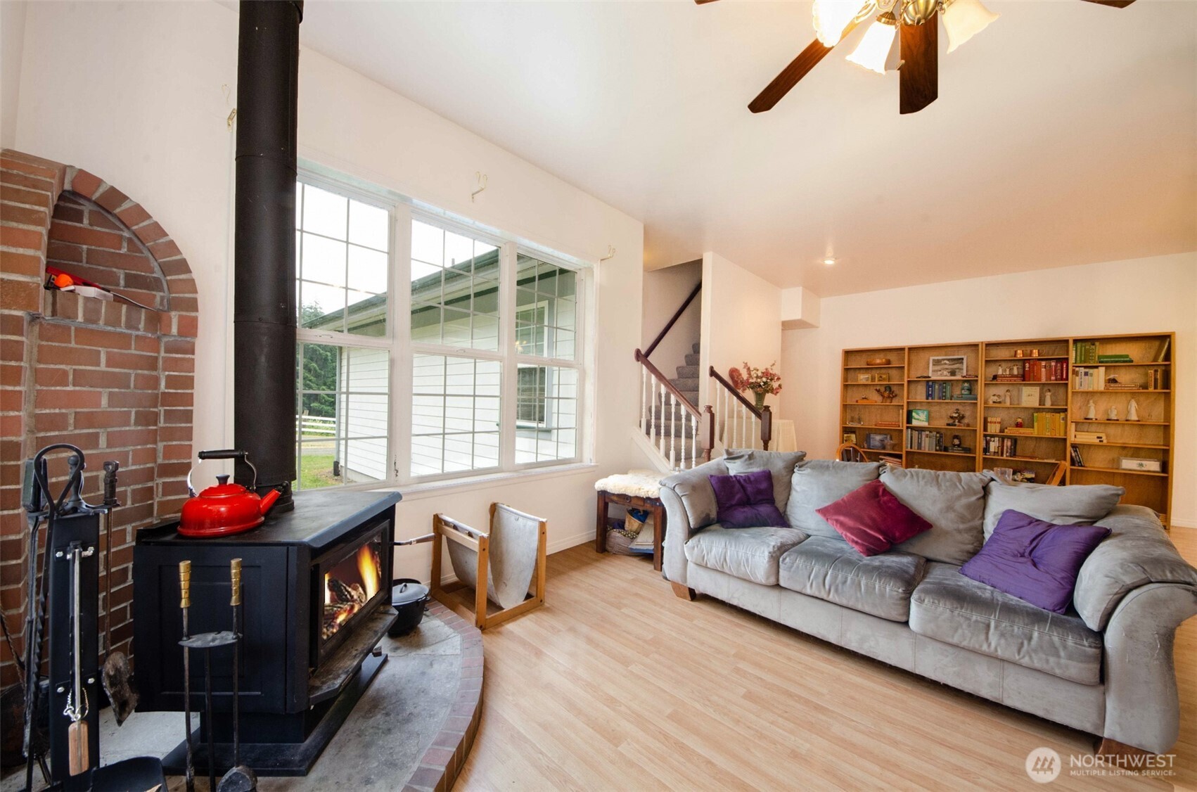 12832 Hunter Road Southwest Rochester, WA 98579 - Photo 5 of 40 a living room with furniture and a floor to ceiling window