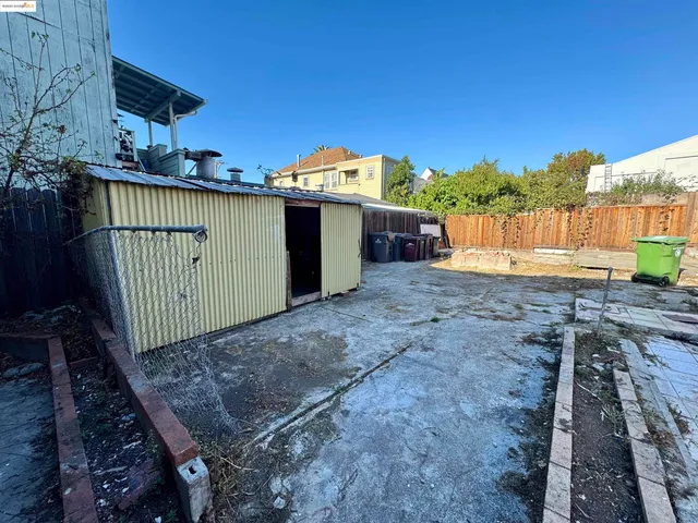 a view of a backyard with wooden fence