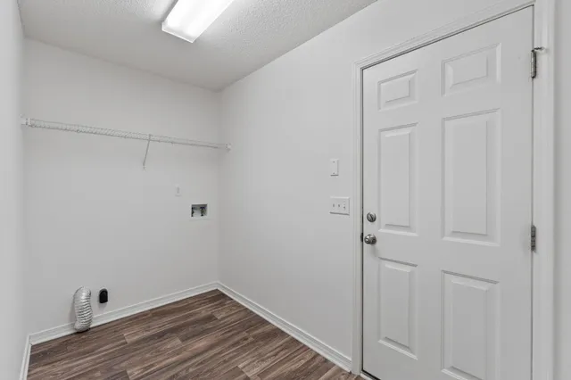 a kitchen with white cabinets white appliances and sink