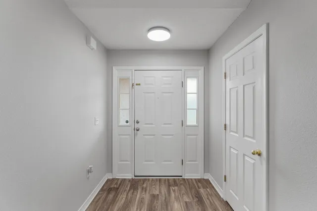 a white building with a floor to ceiling window