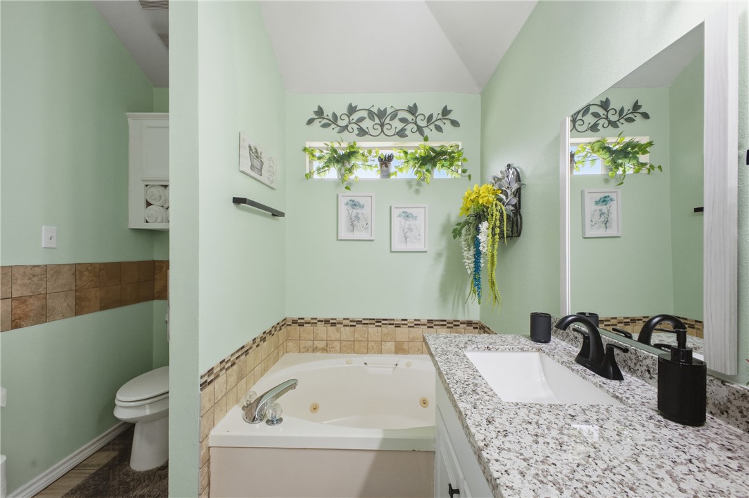 1702 Ibis Court Bryan, TX 77807 - Photo 15 of 18 a bathroom with a tub sink and toilet