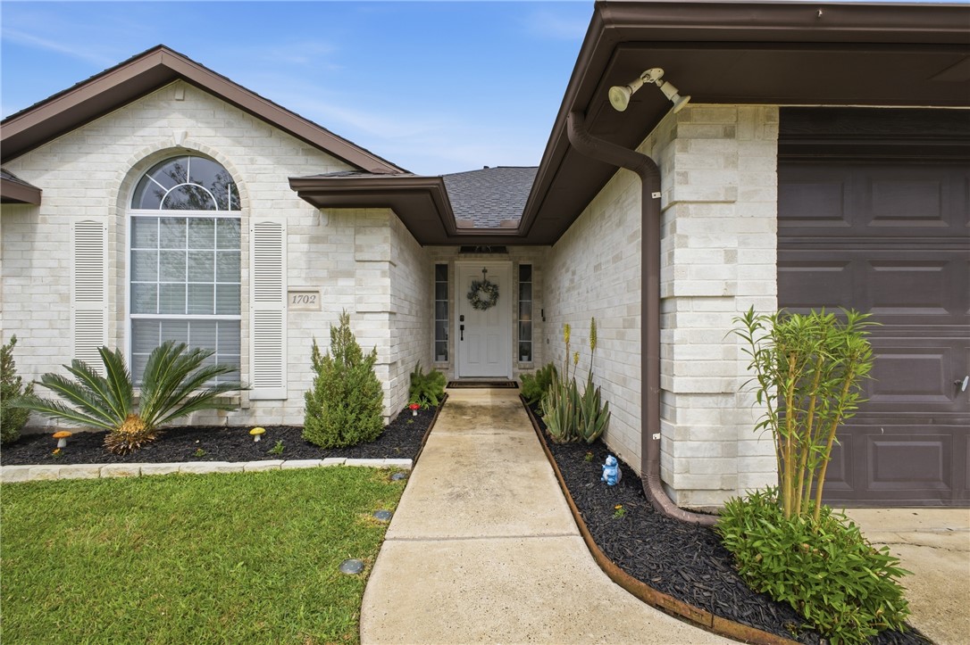 1702 Ibis Court Bryan, TX 77807 - Photo 2 of 18 a front view of a house with a yard