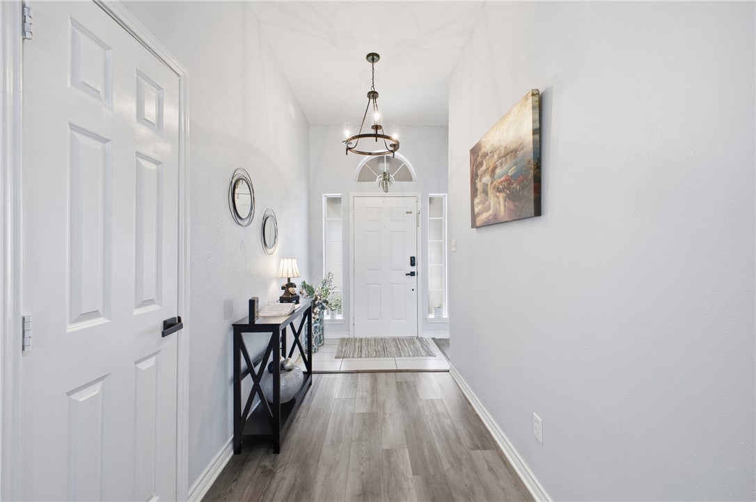 1702 Ibis Court Bryan, TX 77807 - Photo 3 of 18 a view of a hallway with wooden floor
