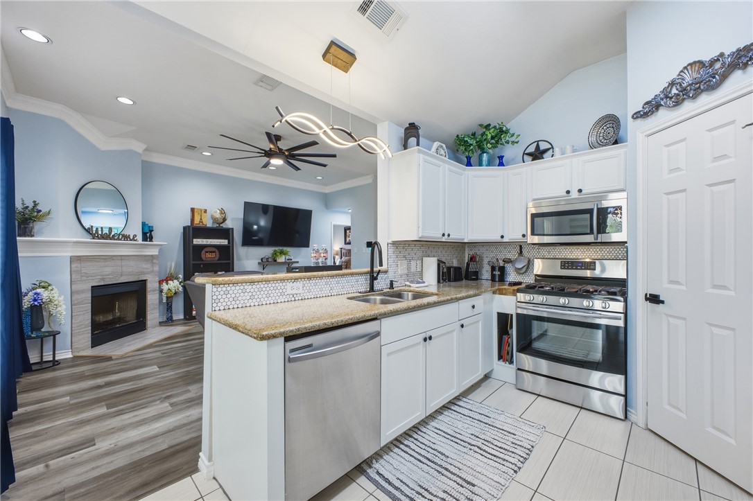 1702 Ibis Court Bryan, TX 77807 - Photo 7 of 18 a kitchen with a sink stove and oven