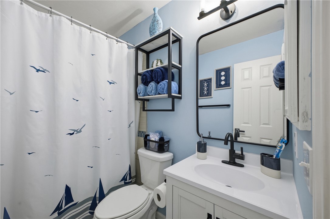 1702 Ibis Court Bryan, TX 77807 - Photo 10 of 18 a bathroom with a sink vanity mirror and toilet