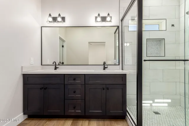 a bathroom with a double vanity sink and a mirror