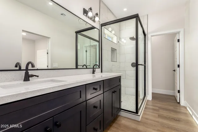 a bathroom with a double vanity sink and mirror