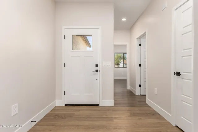 a view of a hallway with wooden floor