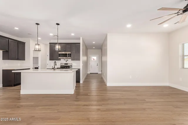 a view of kitchen with kitchen island and stainless steel appliances