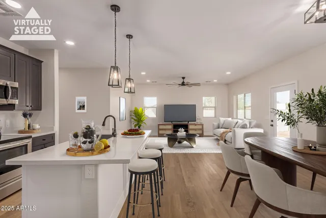 a living room with furniture a chandelier and a flat screen tv