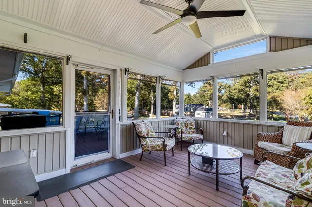 a balcony with wooden floor and outdoor seating