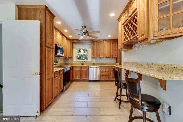 a kitchen with a sink a cabinets and chairs
