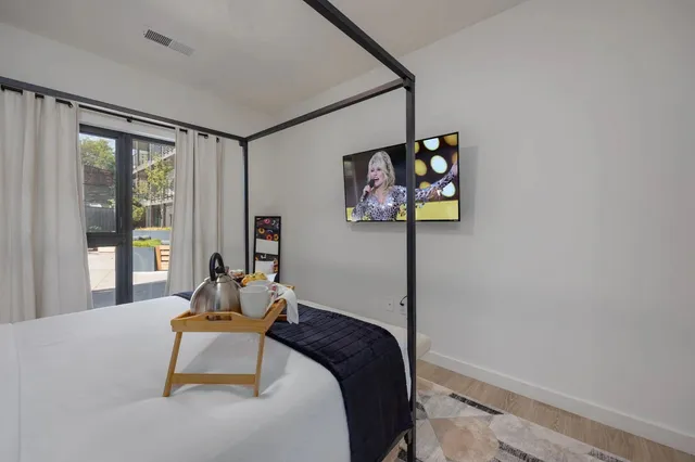 a bedroom with a bed and glass wall