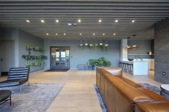 a view of a patio with a table and chairs and potted plants
