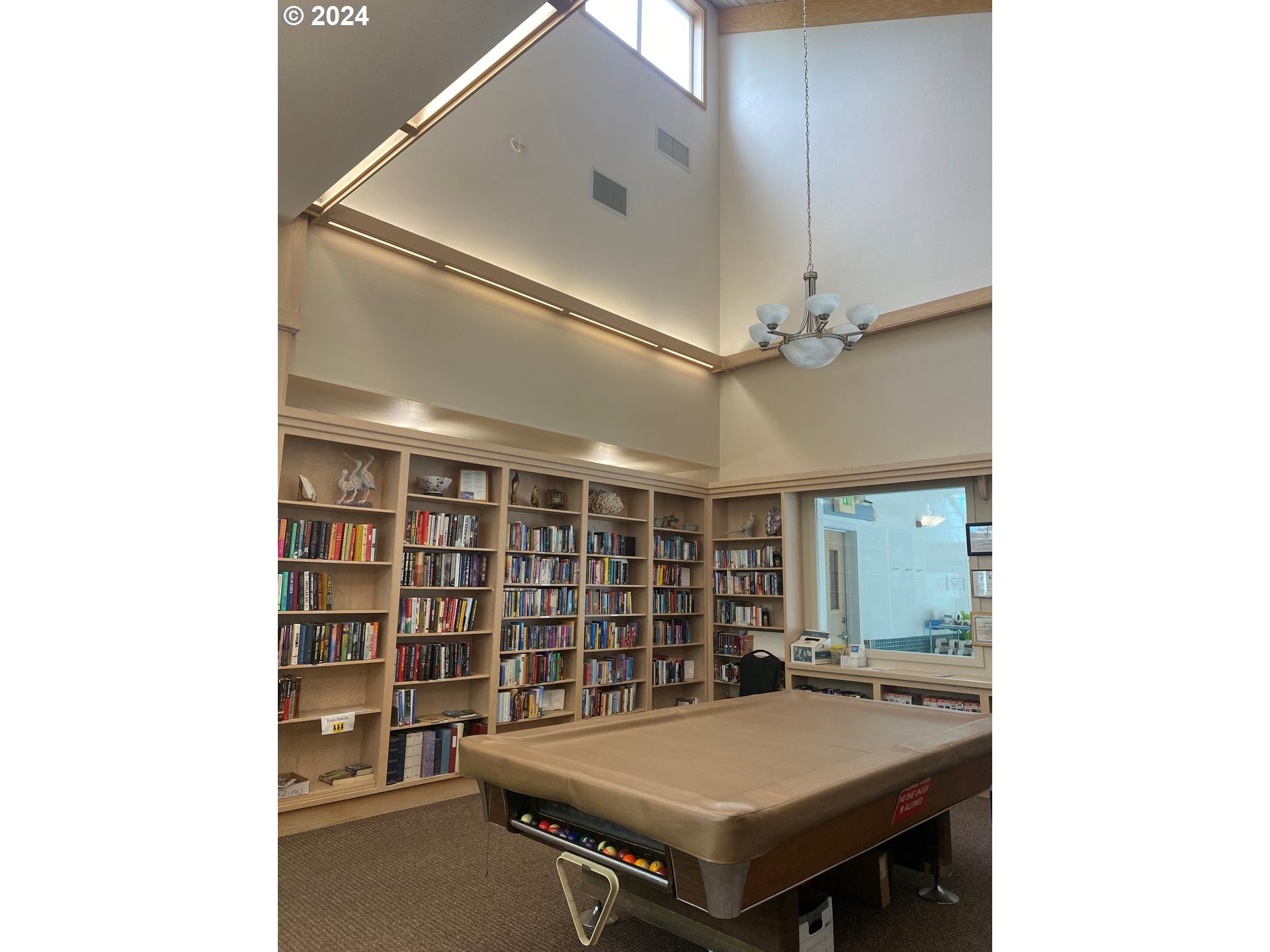 865 Western Way Florence, OR 97439 - Photo 22 of 26 a room with pool table and a bookshelf