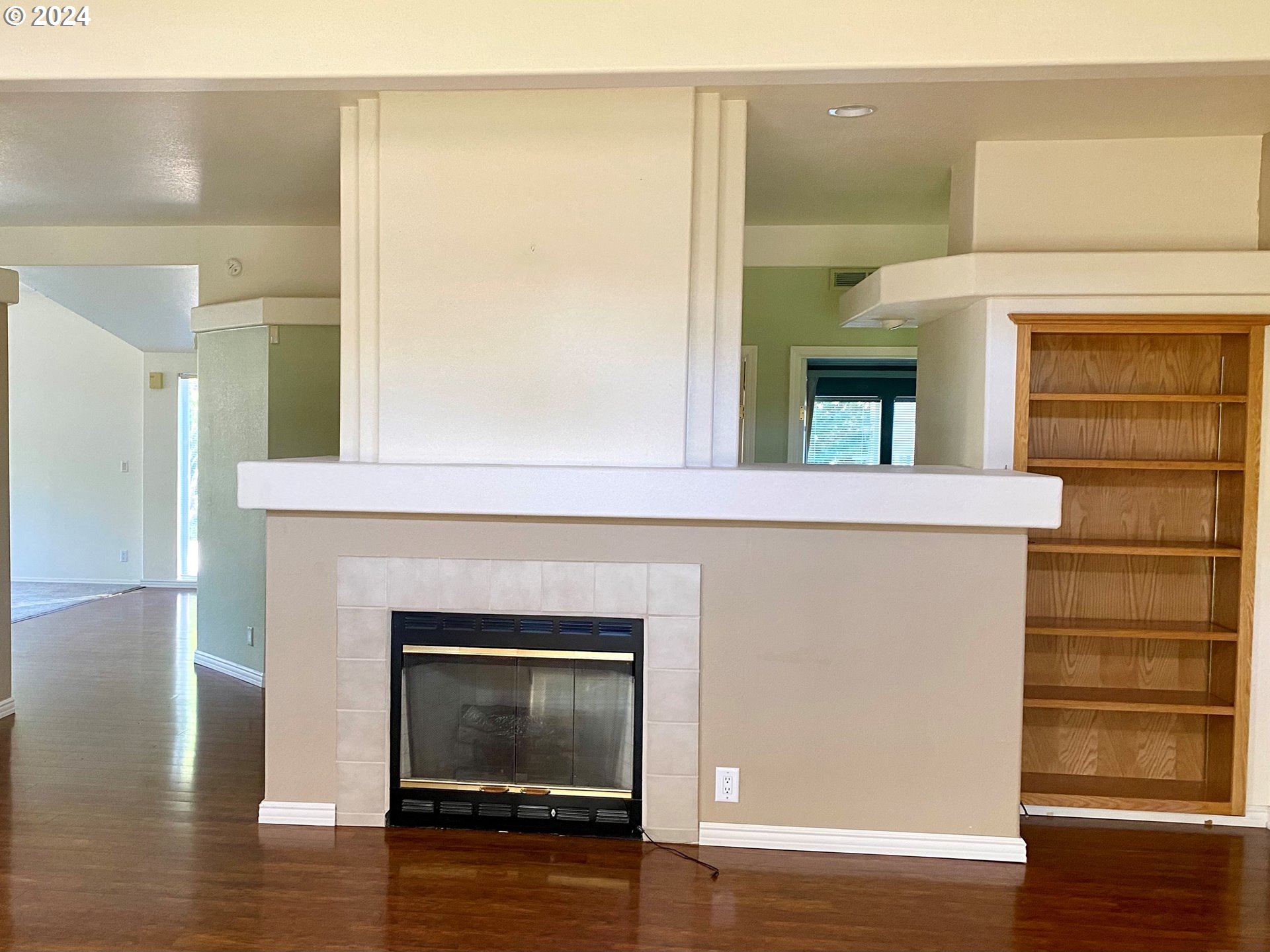 865 Western Way Florence, OR 97439 - Photo 6 of 26 a room with a fireplace and wooden floor