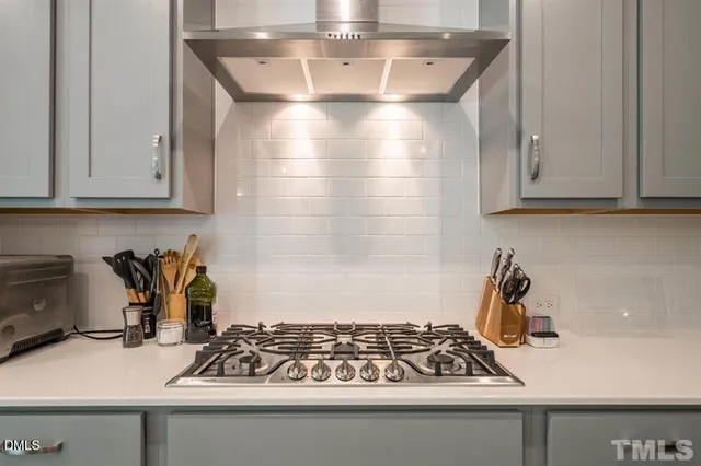 a kitchen with a sink a stove and cabinets