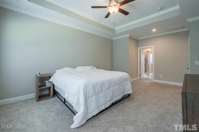 a bedroom with a bed and a ceiling fan