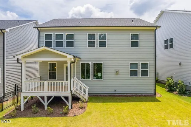 an aerial view of a swimming pool with outdoor seating and yard