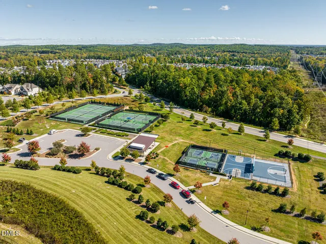 an aerial view of a house with a garden and lake view