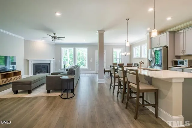 a view of a a dining room with furniture window and wooden floor