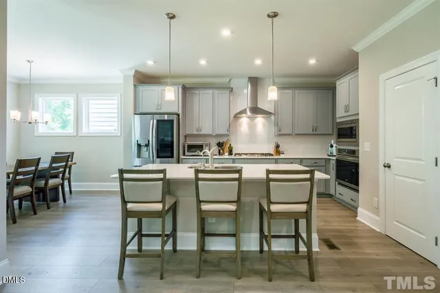 a kitchen with kitchen island granite countertop a table and chairs in it