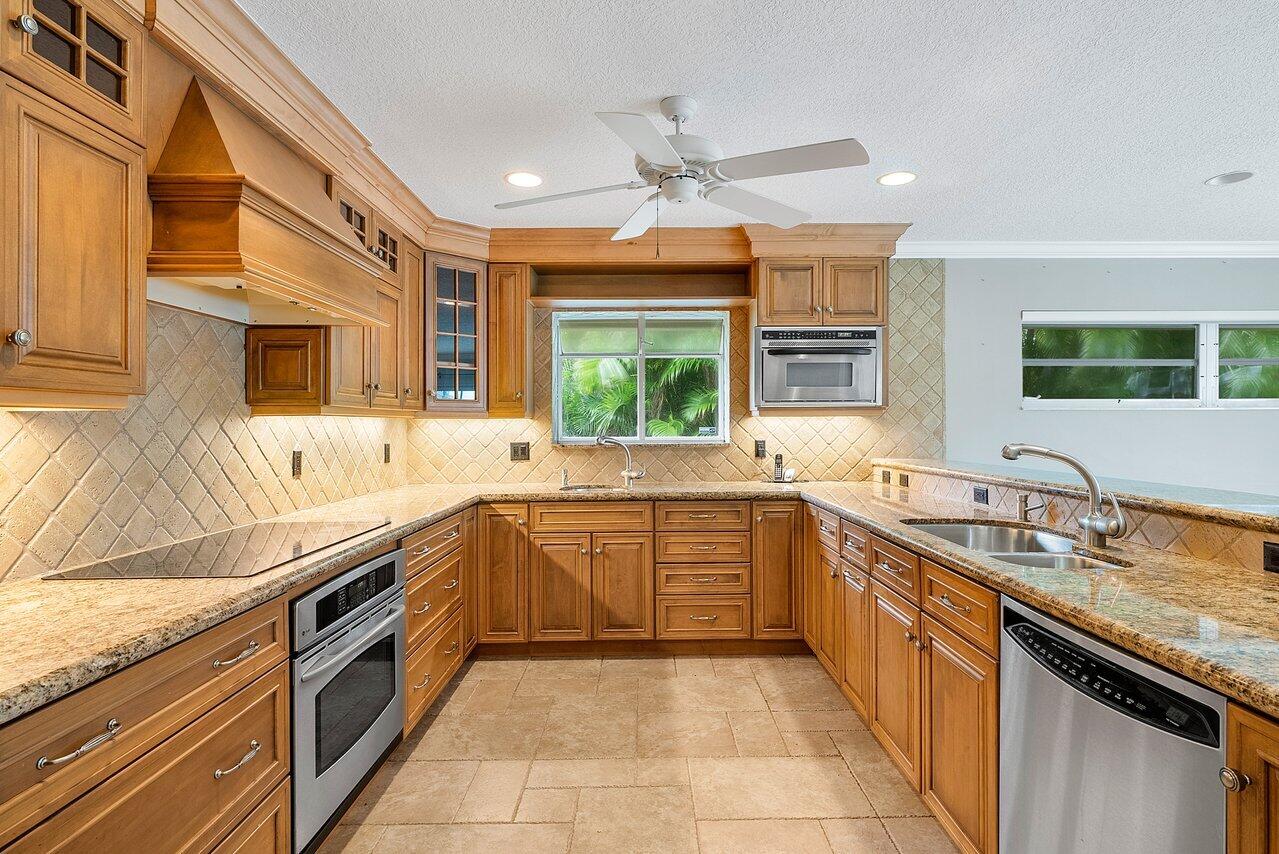 756 Dover Street Boca Raton, FL 33487 - Photo 11 of 29 a large kitchen with stainless steel appliances granite countertop a sink and counter space