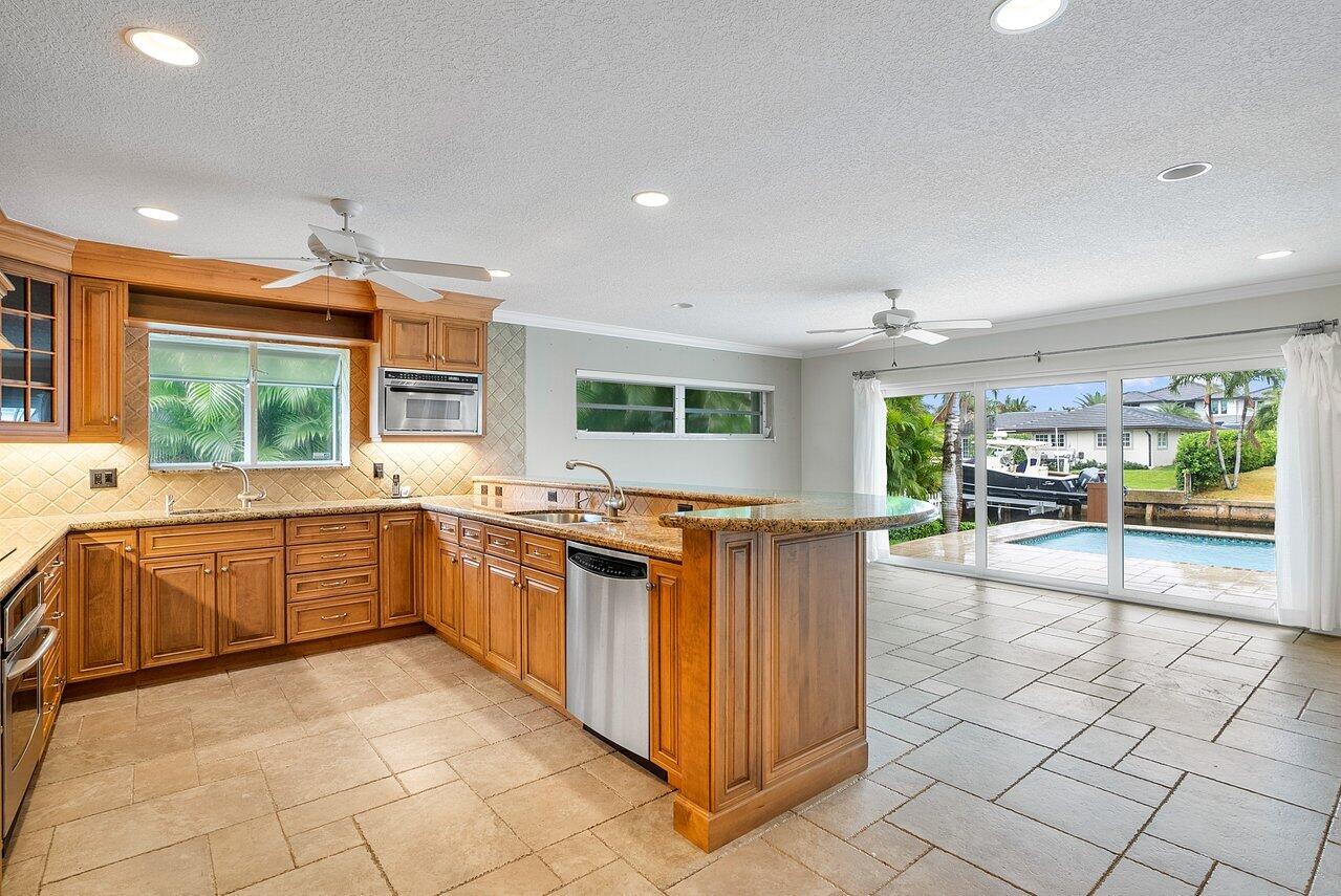756 Dover Street Boca Raton, FL 33487 - Photo 12 of 29 a large kitchen with kitchen island granite countertop a large counter top and stainless steel appliances