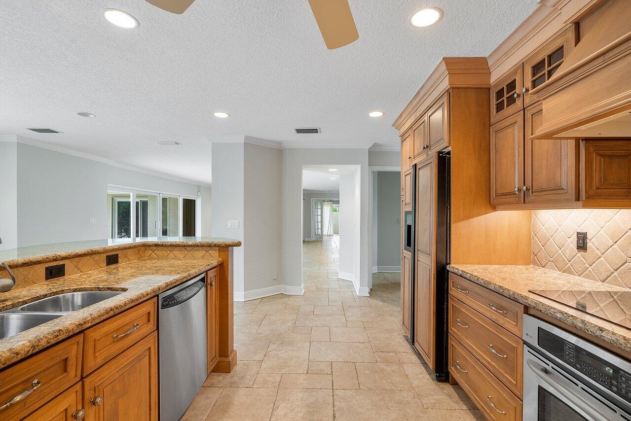 756 Dover Street Boca Raton, FL 33487 - Photo 14 of 29 a kitchen with a sink and a refrigerator