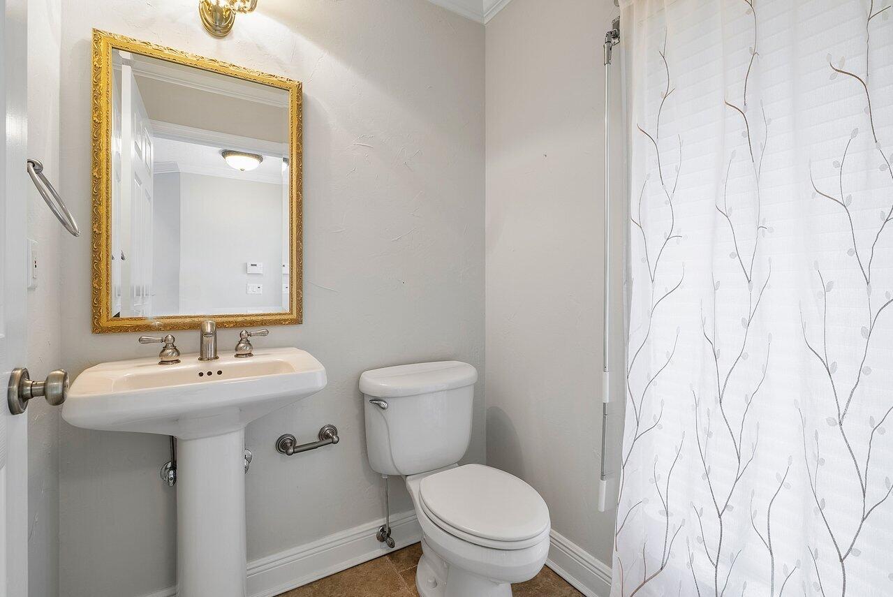 756 Dover Street Boca Raton, FL 33487 - Photo 15 of 29 a bathroom with a toilet sink and mirror