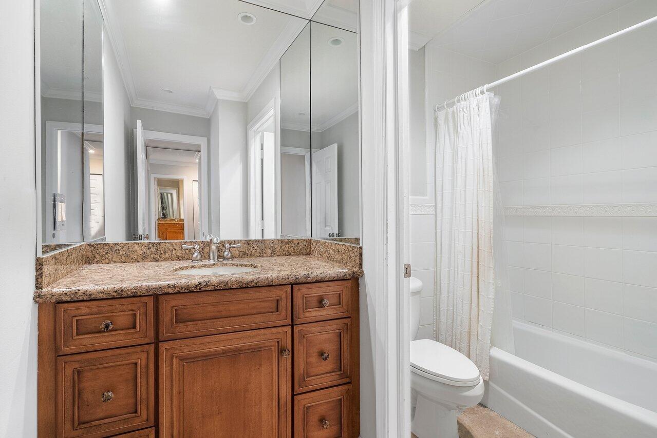 756 Dover Street Boca Raton, FL 33487 - Photo 23 of 29 a bathroom with a granite countertop sink a toilet and a bathtub