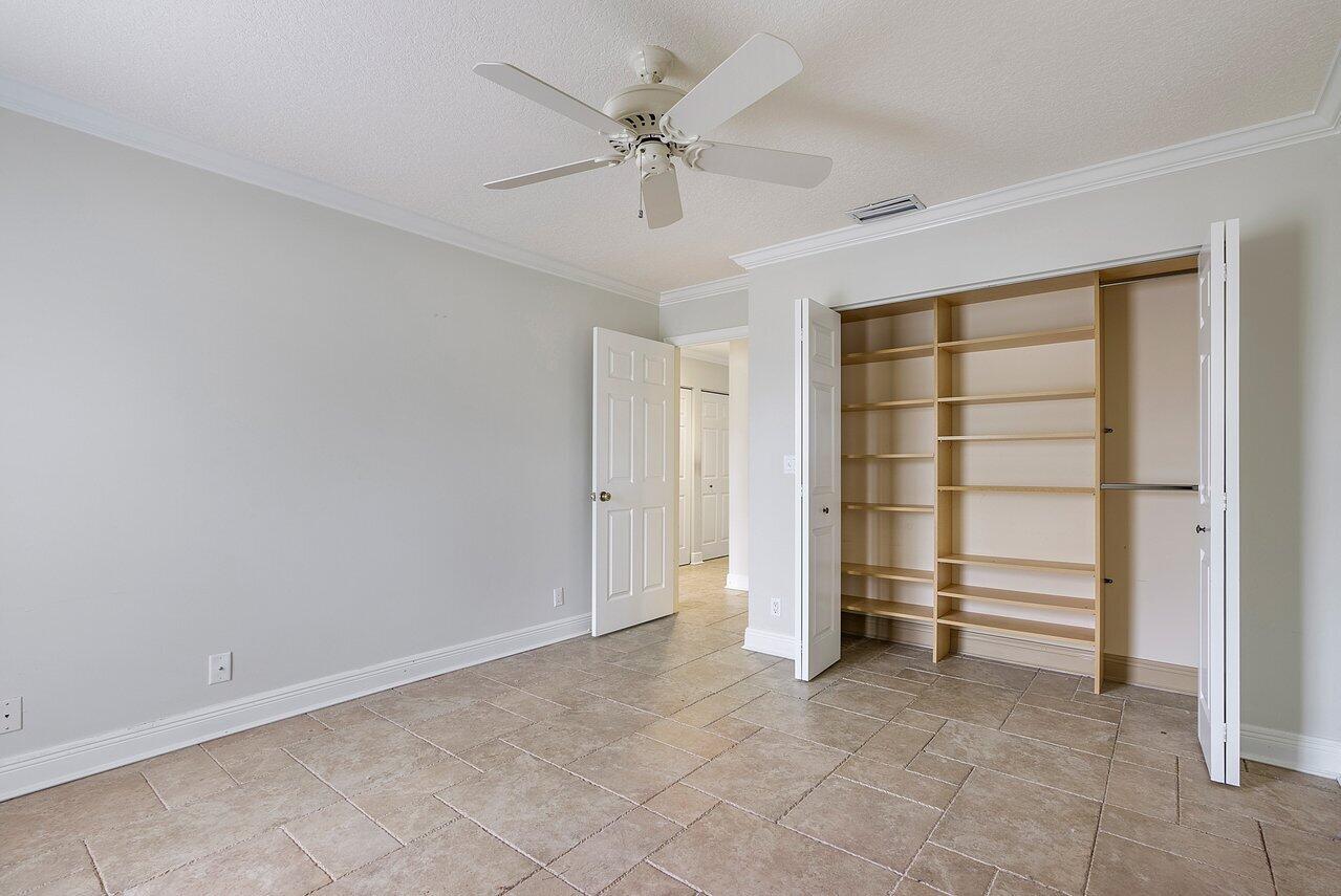 756 Dover Street Boca Raton, FL 33487 - Photo 25 of 29 a view of an empty room with a ceiling fan