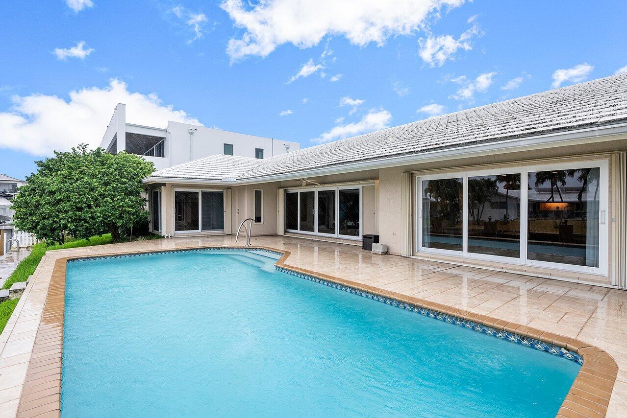 756 Dover Street Boca Raton, FL 33487 - Photo 4 of 29 a front view of a house with swimming pool