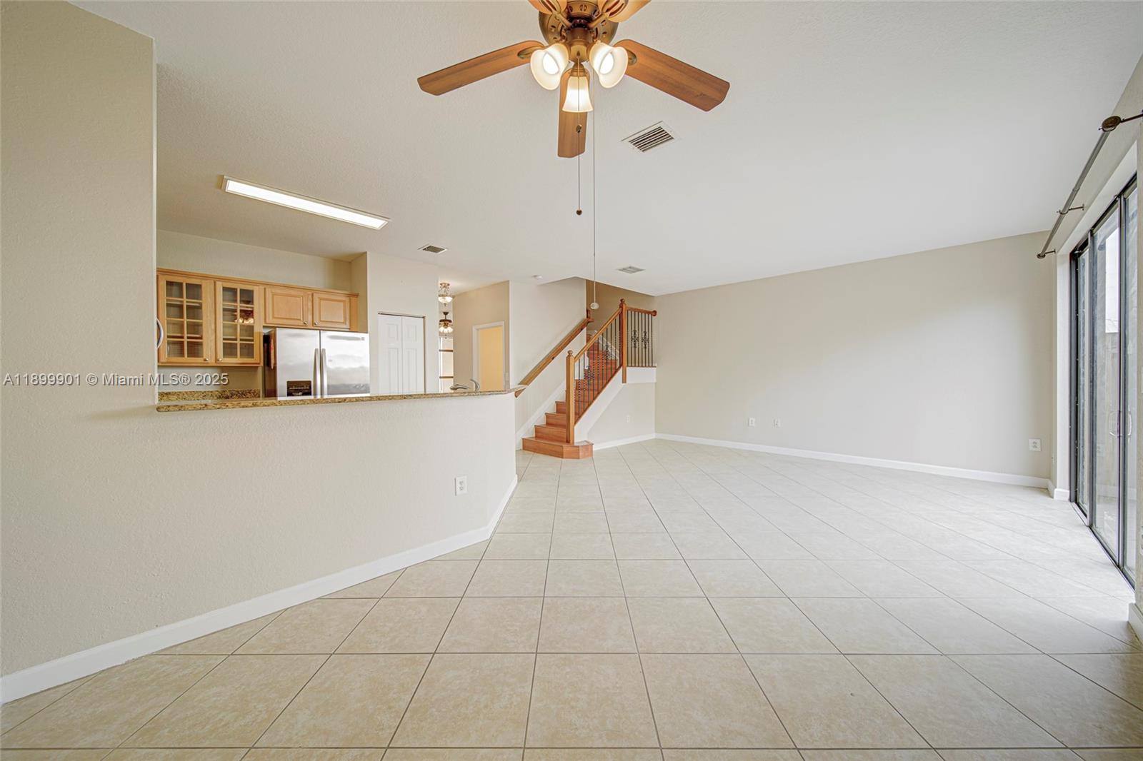 11461 Southwest 236th Lane Homestead, FL 33032 - Photo 17 of 22 a view of a kitchen with furniture and a ceiling fan