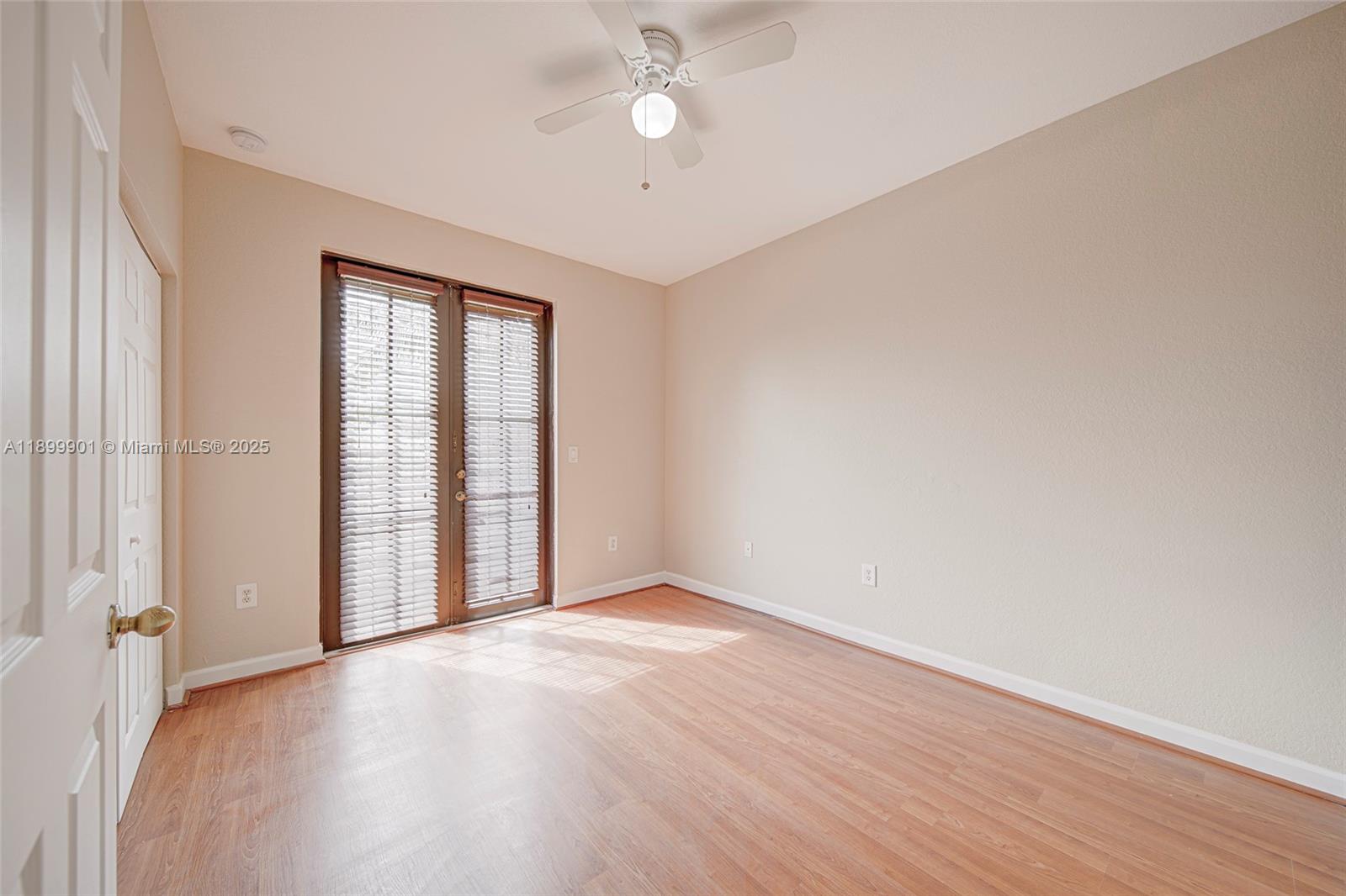 11461 Southwest 236th Lane Homestead, FL 33032 - Photo 19 of 22 an empty room with wooden floor fan and windows