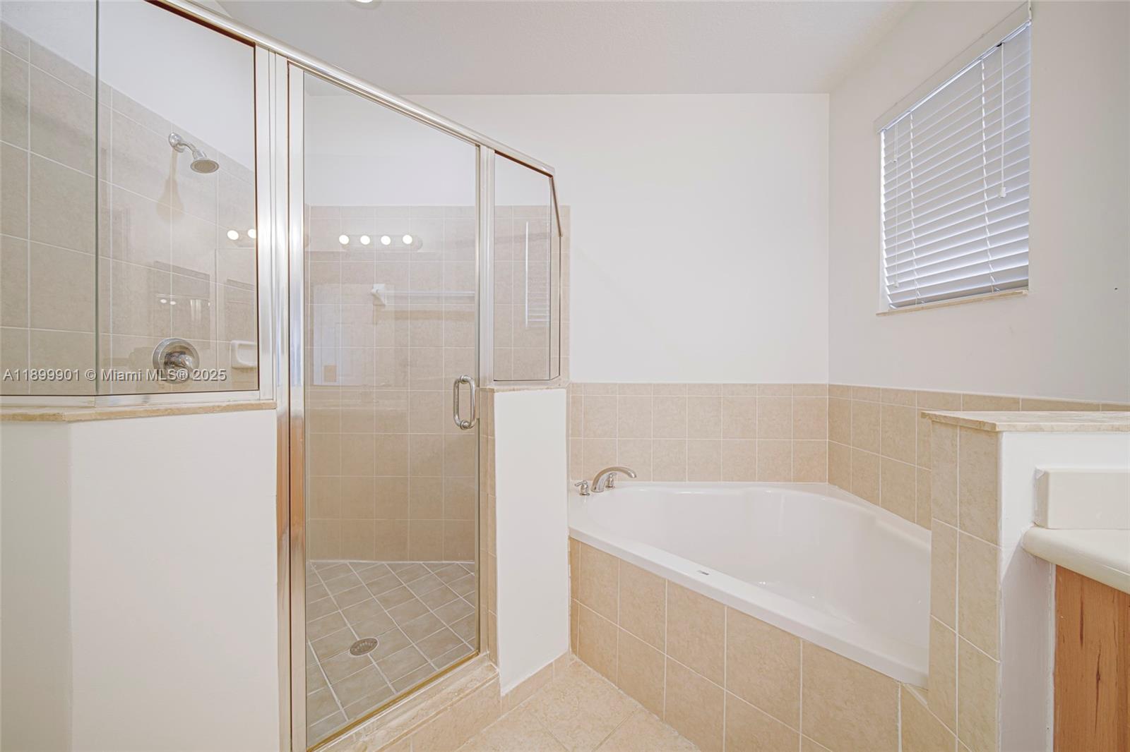 11461 Southwest 236th Lane Homestead, FL 33032 - Photo 7 of 22 a bathroom with a bathtub and a shower