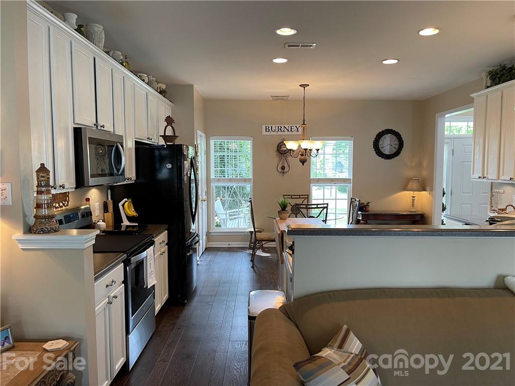 7026 Meyer Road, Unit 384 Fort Mill, SC 29715 - Photo 9 of 29 a kitchen with stainless steel appliances granite countertop a sink stove and refrigerator