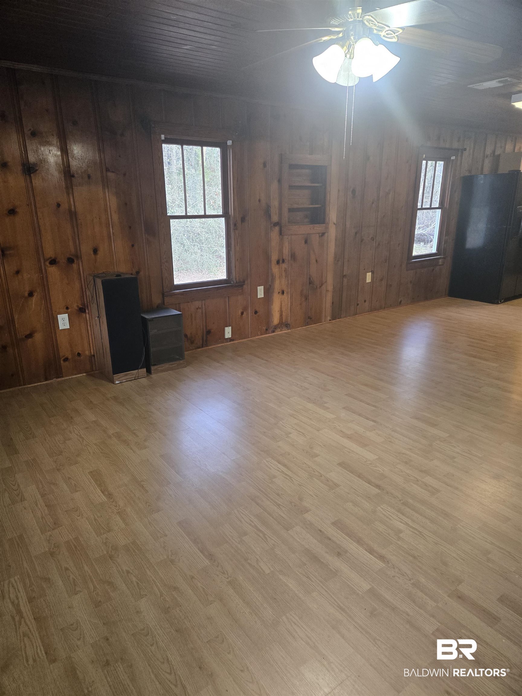 16360 Tolbert Road Bay Minette, AL 36507 - Photo 4 of 14 Unfurnished living room with wood walls, a ceiling fan, and light wood-type flooring