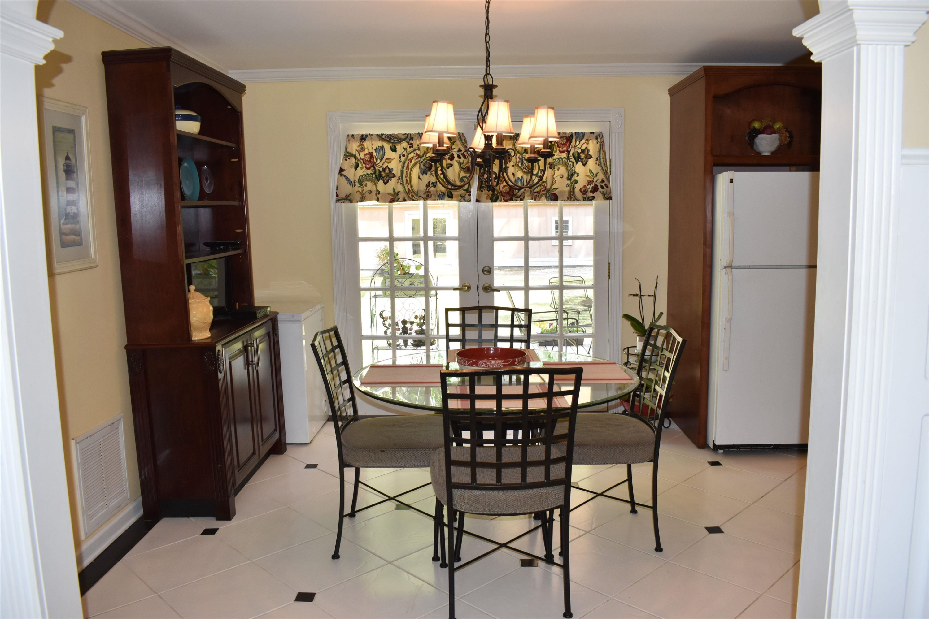 512 Grovemont Road Raleigh, NC 27603 - Photo 5 of 23 Breakfast room w/tile flooring, hanging Chandelier, baseboards, crown molding, 2 doors to outside deck & open to kitchen! Breakfast Area