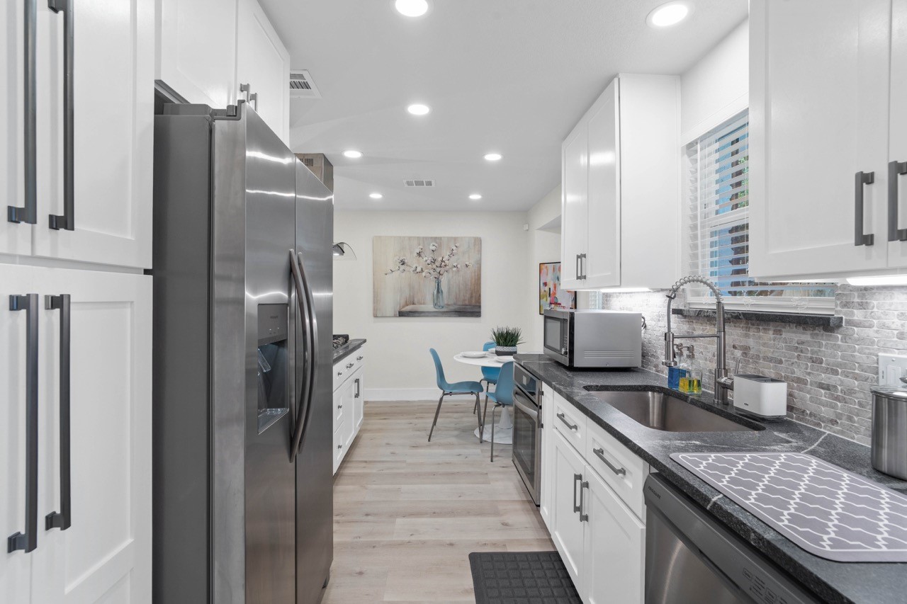 3138 Sunbeam Street Houston, TX 77051 - Photo 26 of 50 Bright soft-close cabinetry, expansive counters, and an open airy layout make this beautifully updated kitchen as practical as it is stunning.