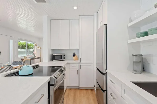 a kitchen with a sink a stove and refrigerator