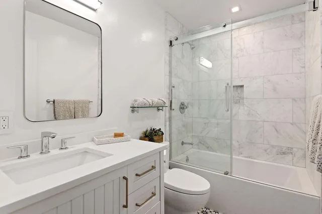 a bathroom with a sink toilet tub and shower