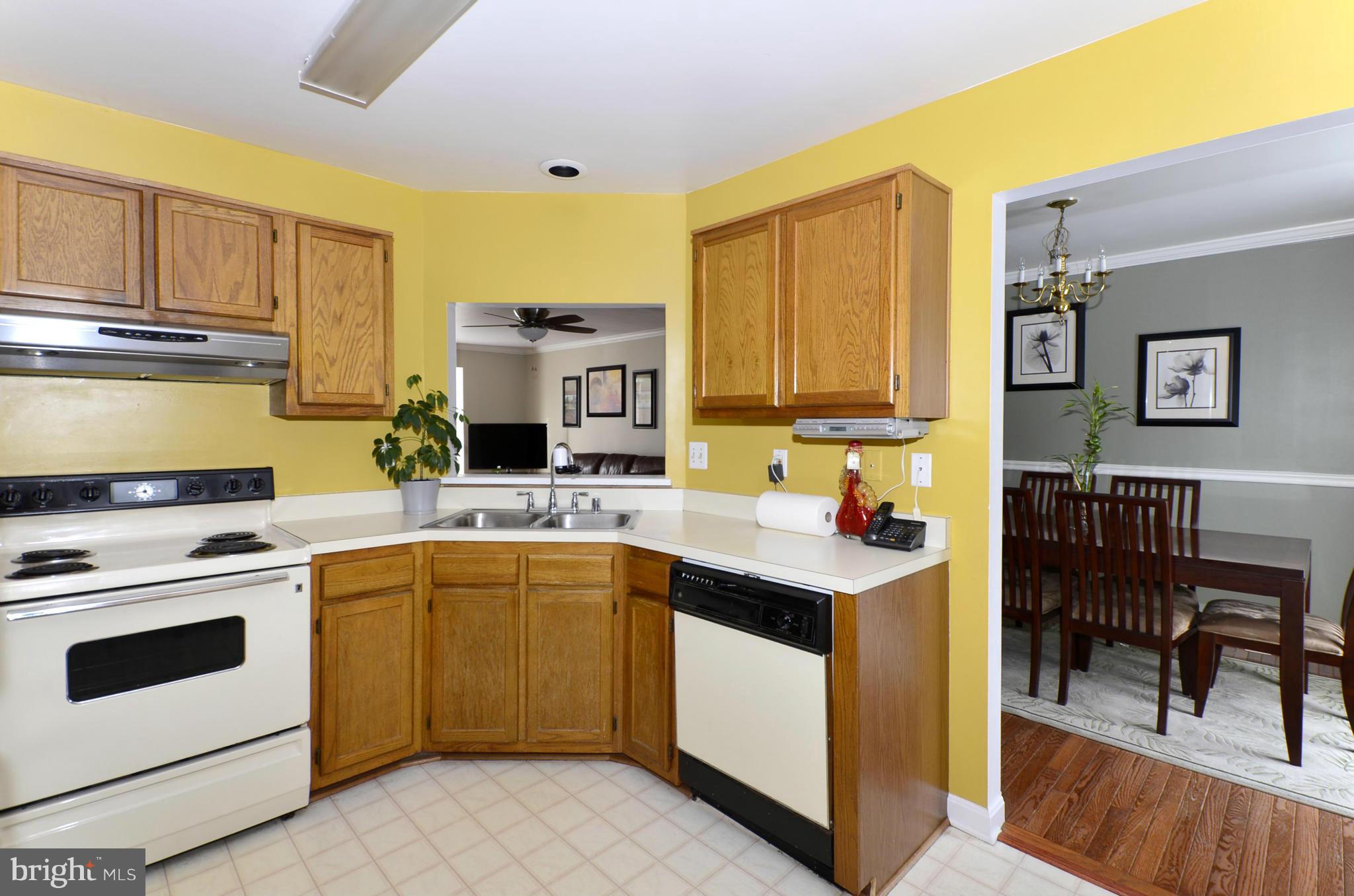 4462 Silver Teal Road Baltimore, MD 21236 - Photo 11 of 30 a kitchen with a sink stove and cabinets