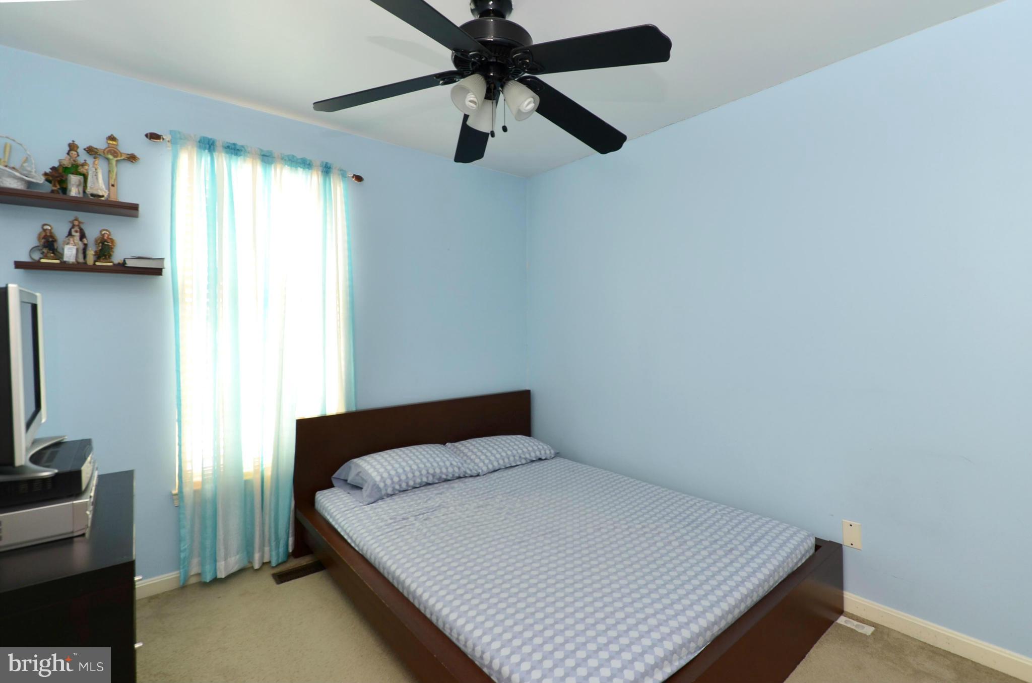 4462 Silver Teal Road Baltimore, MD 21236 - Photo 15 of 30 a bedroom with a bed and a tv