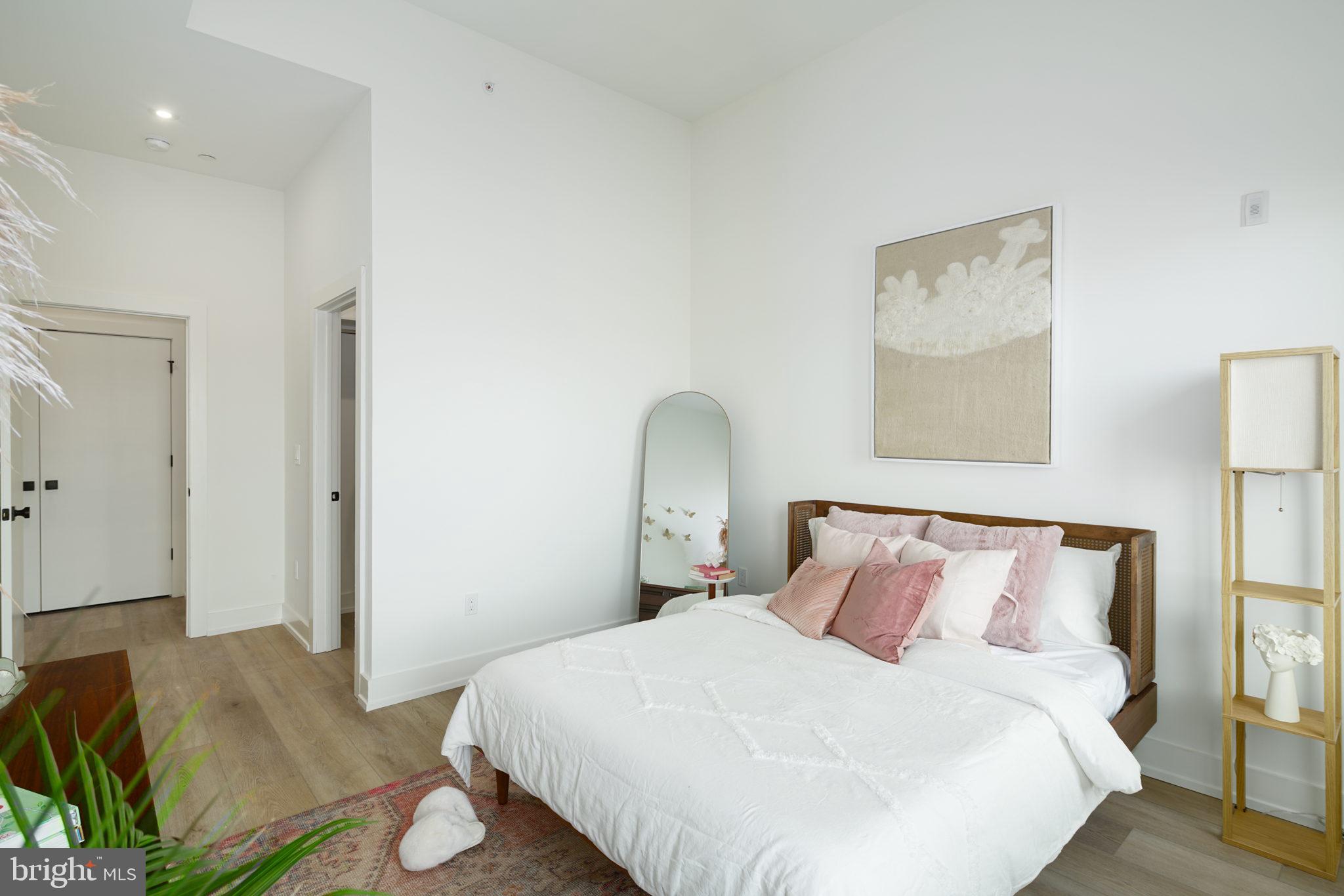 5013 Springfield Avenue, Unit 408 Philadelphia, PA 19143 - Photo 7 of 15 a bedroom with bed and wooden floor