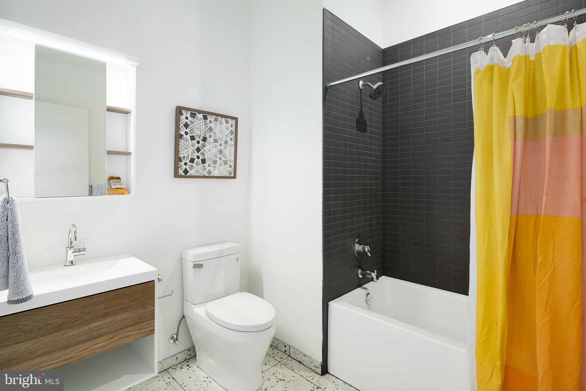 5013 Springfield Avenue, Unit 408 Philadelphia, PA 19143 - Photo 10 of 15 a bathroom with a sink a toilet and shower