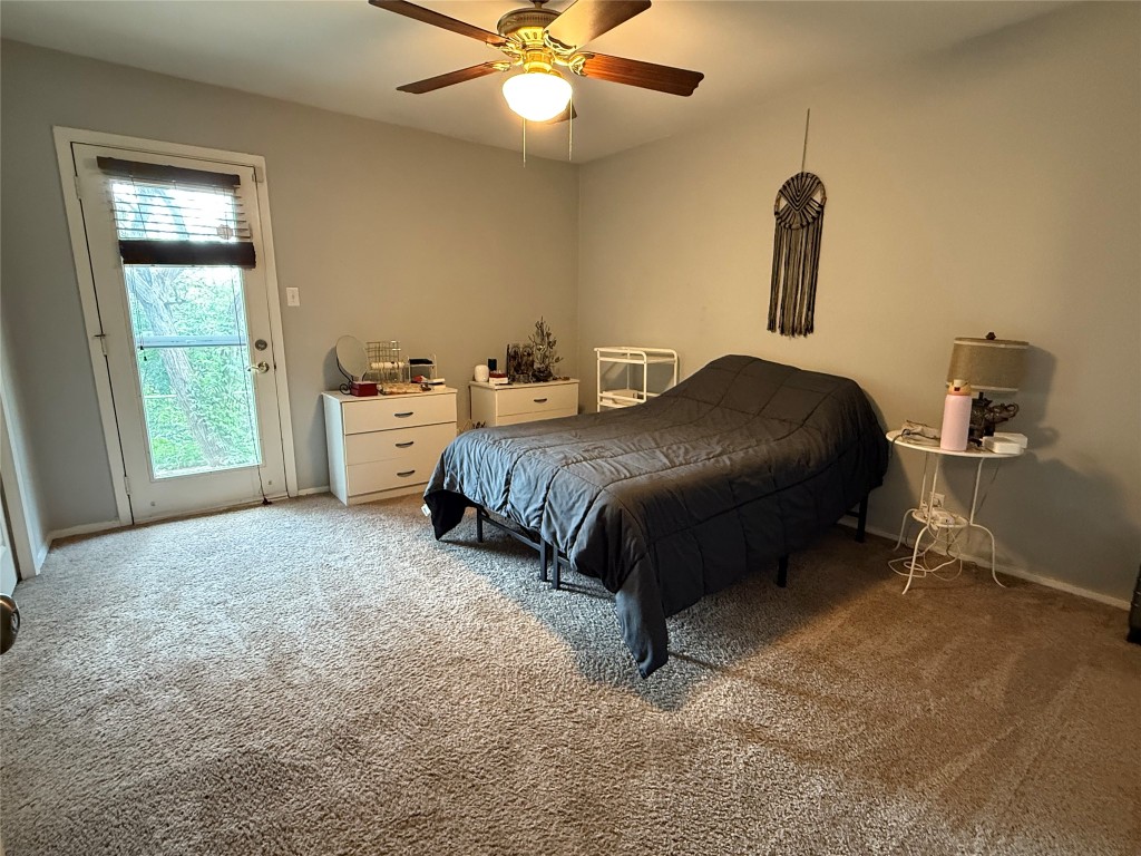 816 Ramble Lane, Unit B Austin, TX 78745 - Photo 13 of 27 a spacious bedroom with a bed and a chandelier
